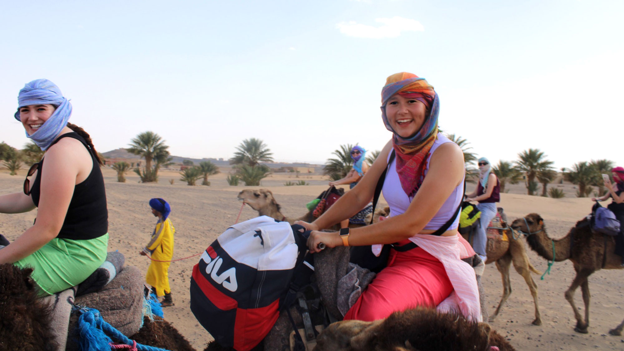 Two female Eramus students on camels as part of the International Studies Programme