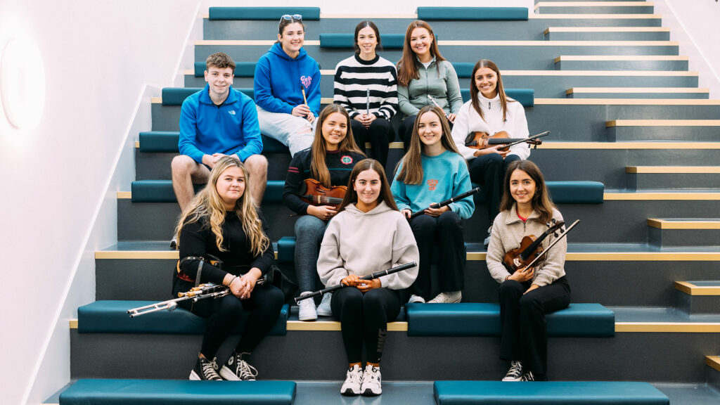 Traditional music students sitting on the communal staircase