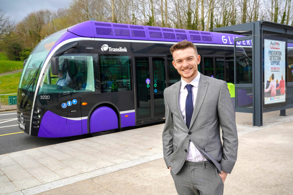 Workplace learning student standing beside Glider on Falls Road