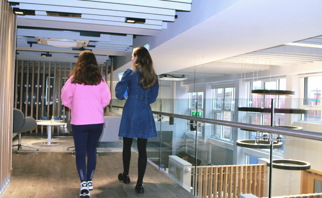 2 BA students chatting in the Careers reception.