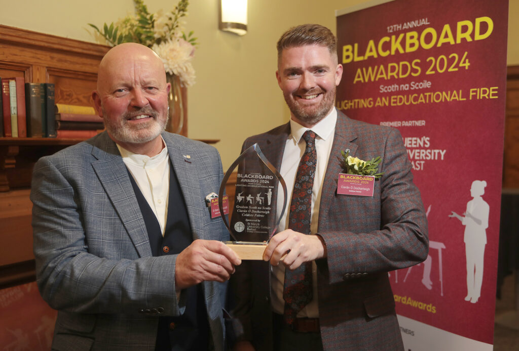 Dr Seán Mac Corraidh of St Mary's University College presents the award for the teacher in an Irish Medium School who made the greatest community impact to Coláiste Feirste teacher Ciarán Ó Dochartaigh