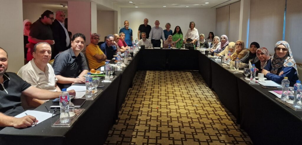 Audience seated round a u-shaped table in a hall at a St Mary’s University College Belfast educational discussion with teachers from Gaza.