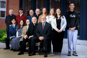 Professor Peter Finn with four priests, students and lecturers in the st mary's quad